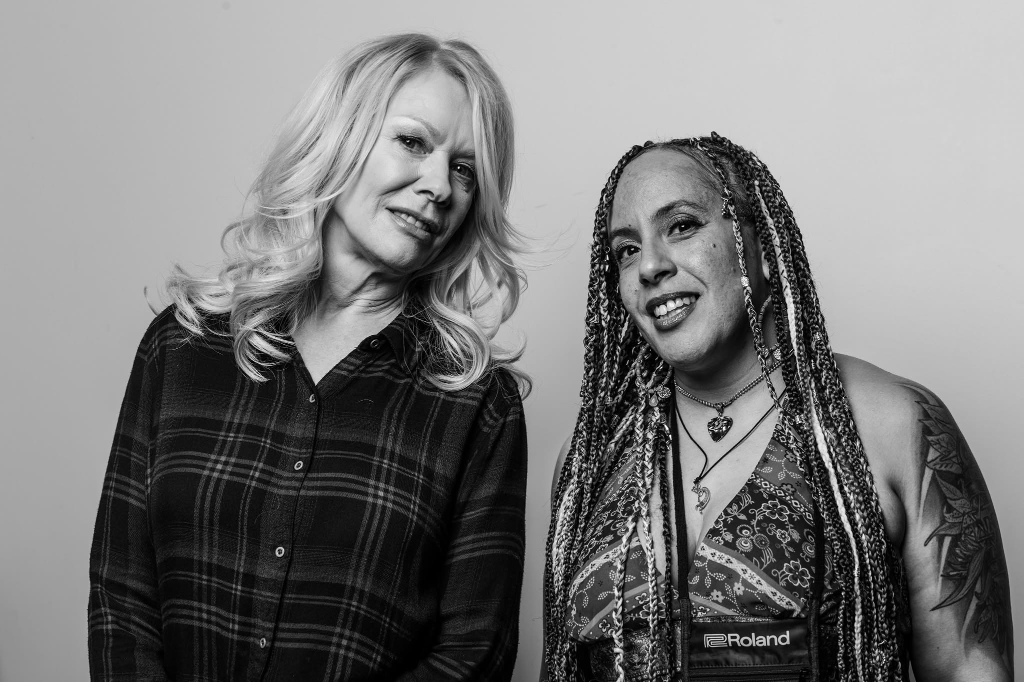 Merry Adin in a black-and-white portrait with a fellow musician
